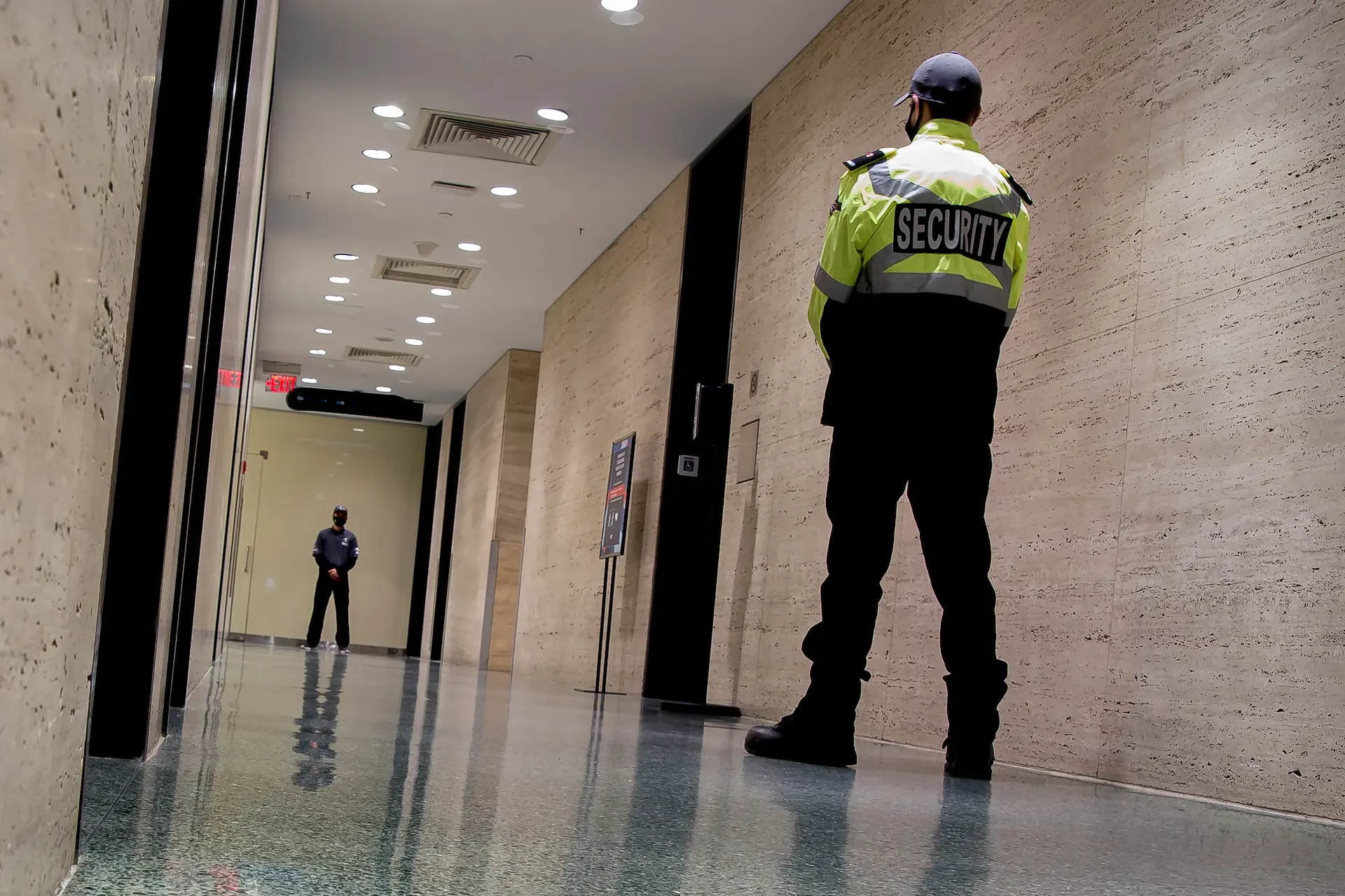 low-angle-shot-of-security-guards-patrolling-insid-2025-02-09-01-04-34-utc